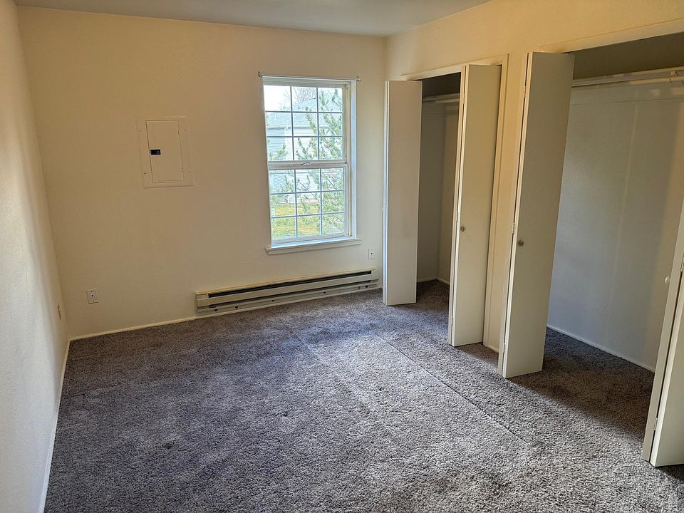 Bedroom with large closet and freshly cleaned carpet.
