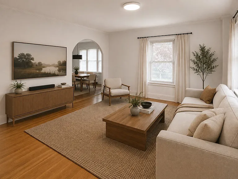 Bright living room leading into dining room, virtually staged