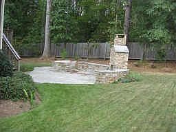 stone fireplace off of the outside patio