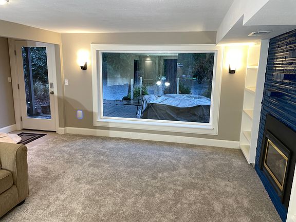 Living room area with a working gas fireplace and a view of the lake.