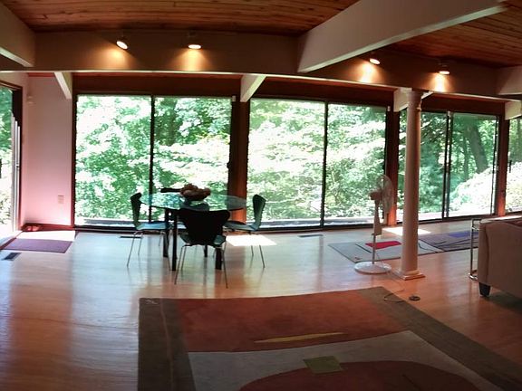 Main level living room area surronded by glass doors