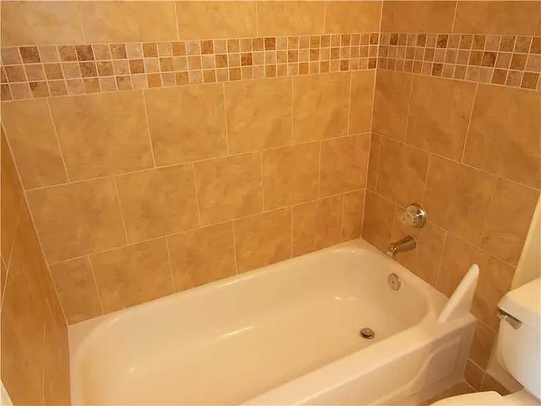 Updated second floor private shower/bath combination.
