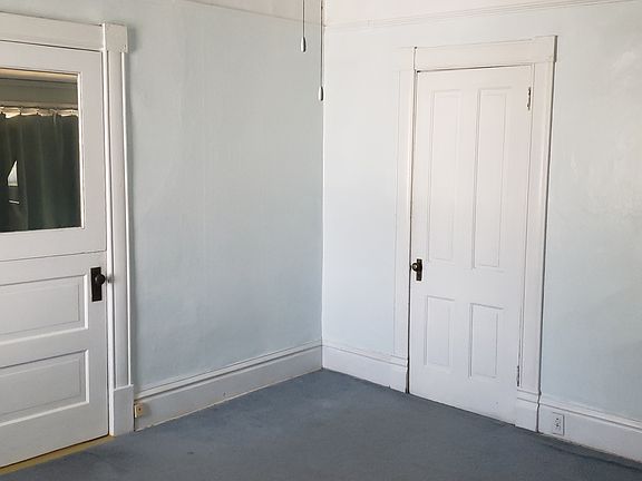 The windowed door to the east bedroom from the living room. The other door is to a large closet.