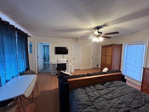 furnished with desk, office chair, queen bed set, table and chairs