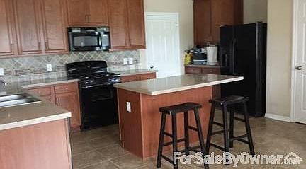 Kitchen
						:
						With island. Open floor plan to the living room and the breakfast room!