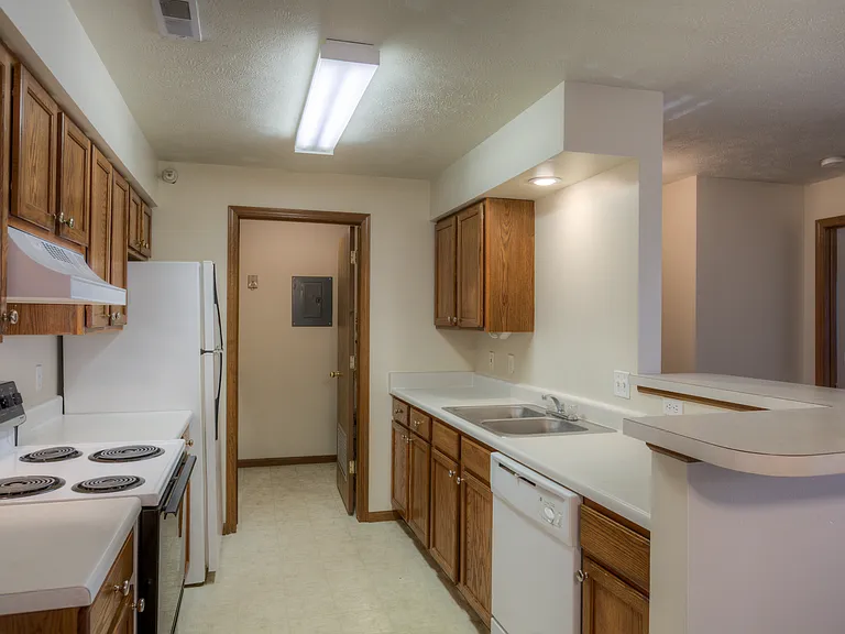Large kitchen with white appliances at Huntington Apartments.