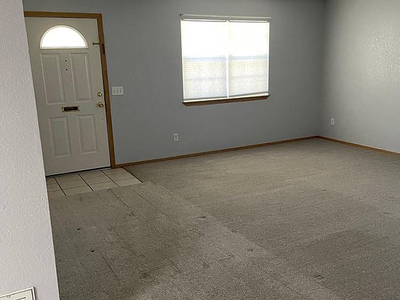 living room with tray ceiling & ceiling fan
