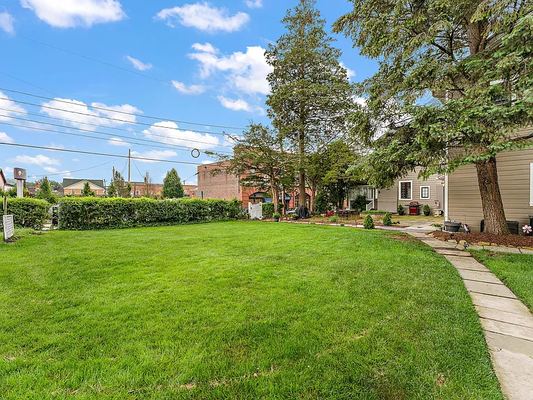 Yard with walkway from designated parking spot on McCready Way.