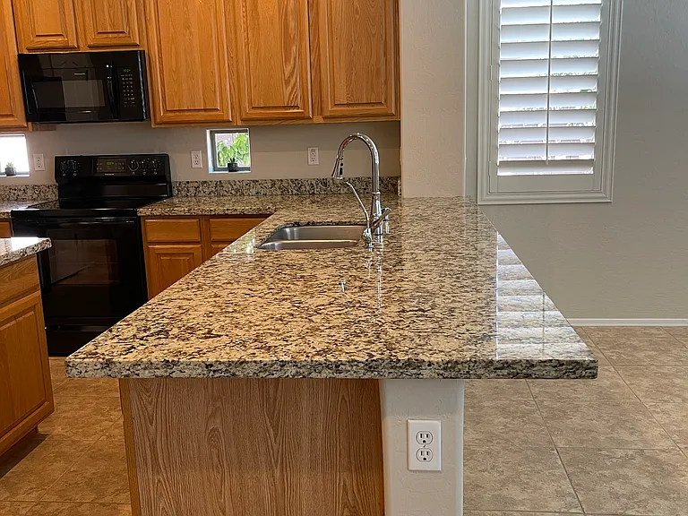 Kitchen peninsula with countertop with room for counter stools.