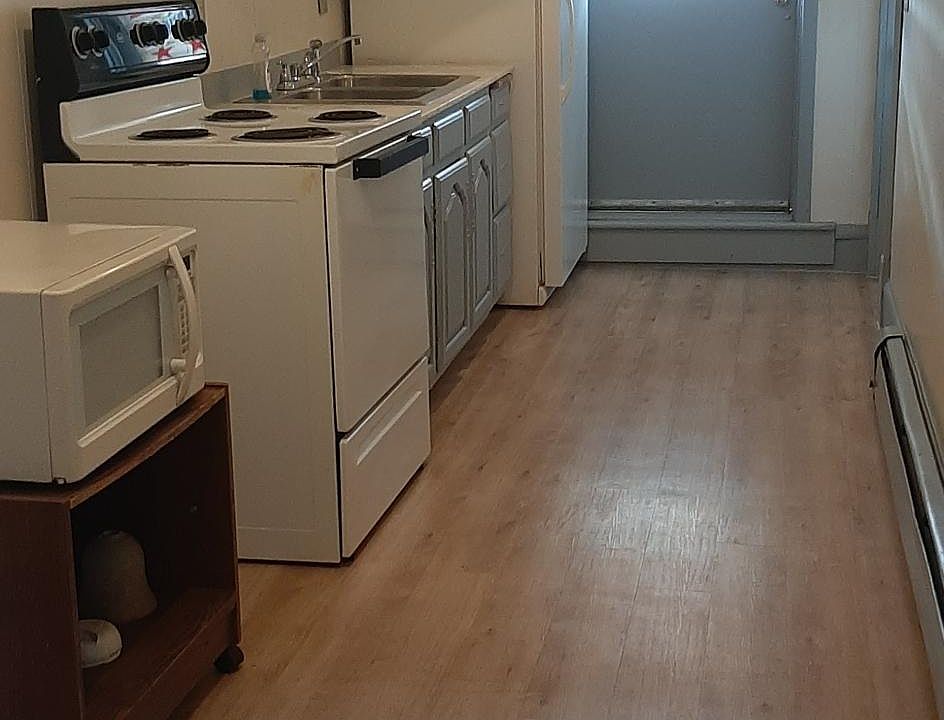 Kitchen has new floor. Stove and refrigerator stays.