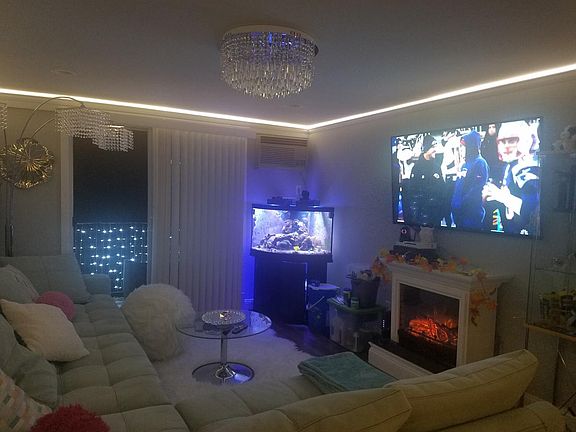 Living room w 60" TV and fireplace