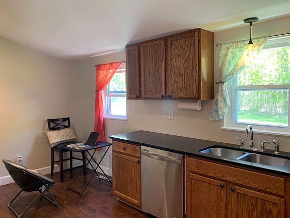 Kitchen photo of coffee area, dishwasher, and dual stainless steel sinks.