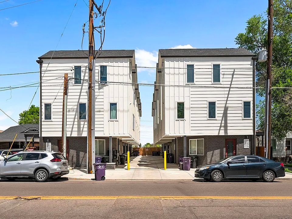 Modern two-story duplex with a sleek white facade and convenient parking.