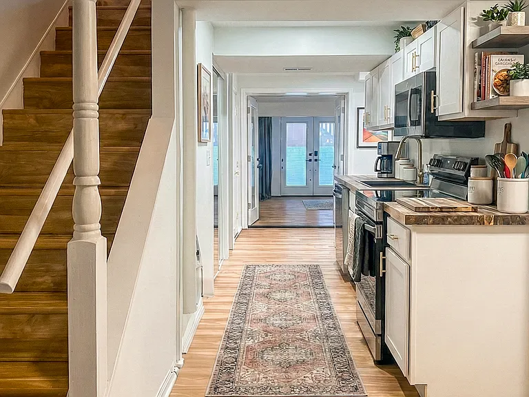 Secondary interior entry hallway with updated wood-style flooring and a clean, modern look.