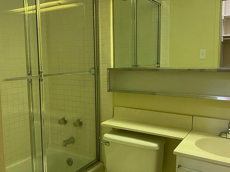 Bathroom has glass enclosed shower.