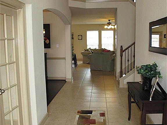 Notice the EXQUISITE details found throughout this home such as the double French doors on the home office, crown millwork & chair rail mouldings & iron stair railings!