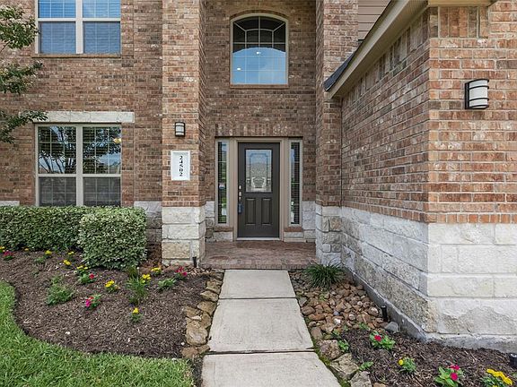 Fresh landscaping and covered porch is a wonderful place to greet visitors.