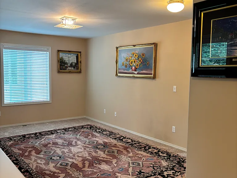 Open-concept loft-style living area with vaulted ceilings and great natural light. This versatile space can be used as a lounge, home office, yoga area, or creative studio. Warm and welcoming _ ideal for quiet evenings or weekend relaxation.