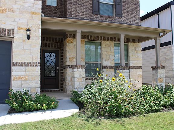 The beautiful bubbled glass door with wrought iron detail provides a touch of privacy and class