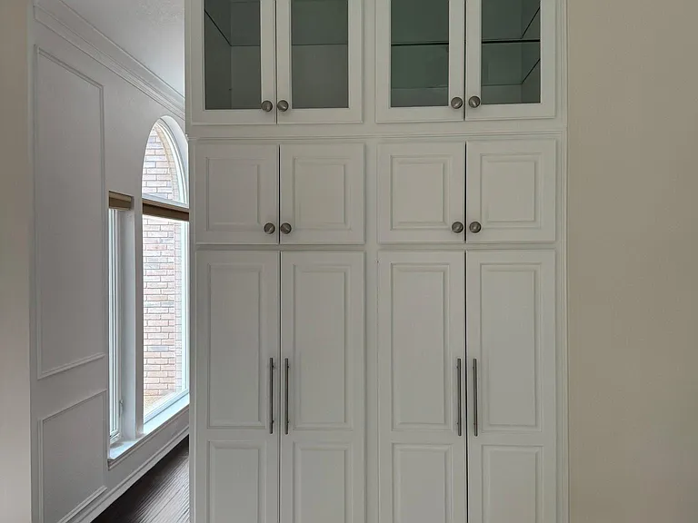 Pantry with lighted display cabinets.
