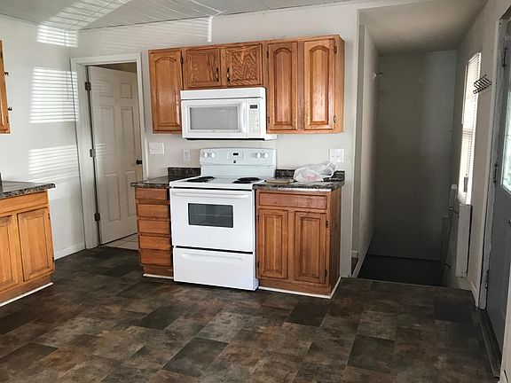 North kitchen wall with bathroom entrance on left and basement stairs on right side of the photo