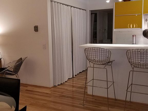 Looking into the Kitchen with bar counter for guest to keep the chef company