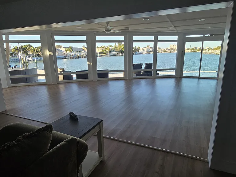 Living room looking into 2nd living room. Floor to ceiling water views.