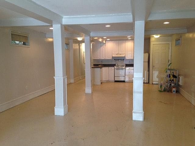 Extra large bright studio with concrete floors.