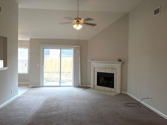 Living room with fireplace & tall ceilings