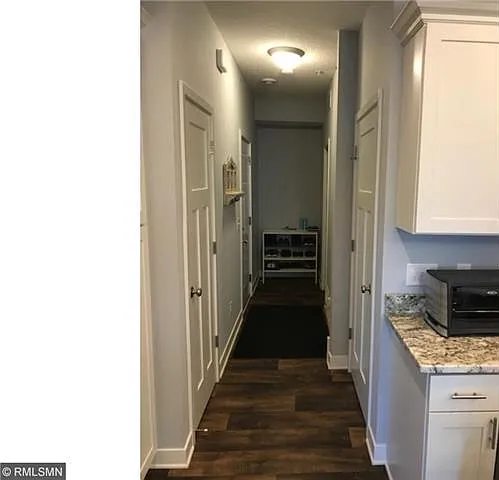 Hall with garage entrance, half bath and closet