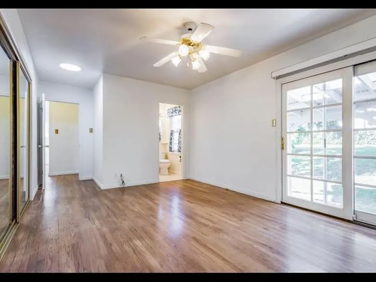 Upstairs larger bedroom - mirrors are all closets which have built ins inside. You can see the small en suite bathroom here
