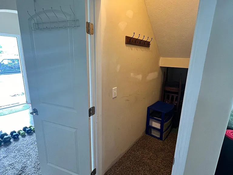 large storage closet under staircase
