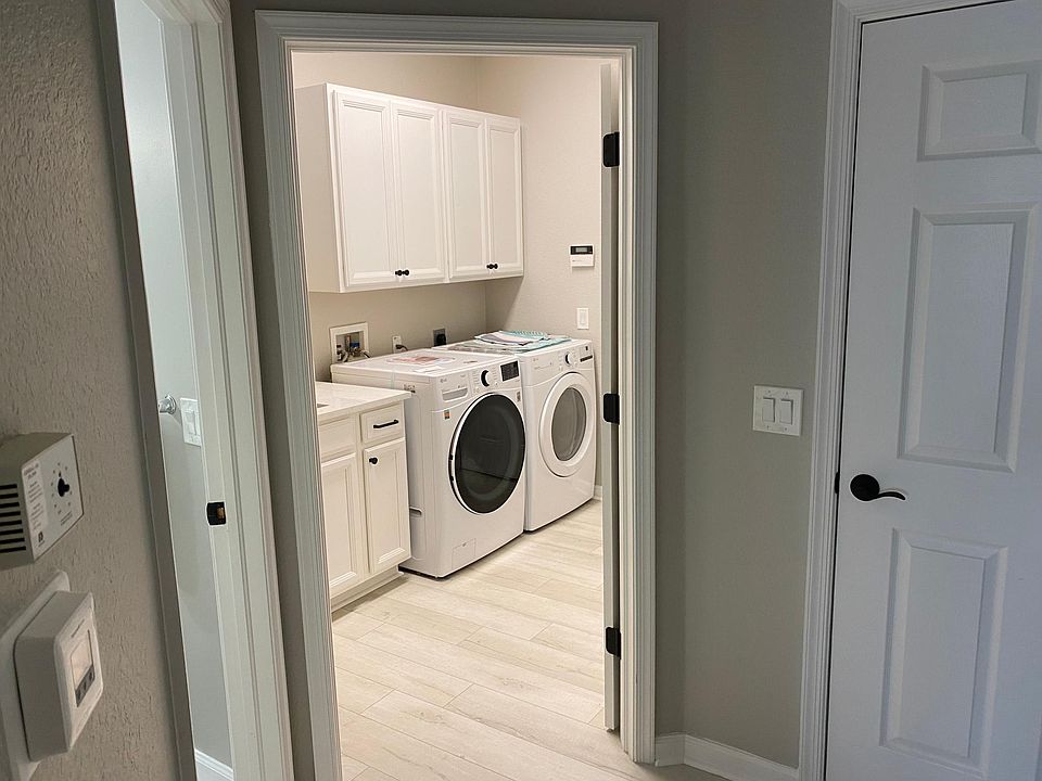 Laundry room leading out to a two car garage.