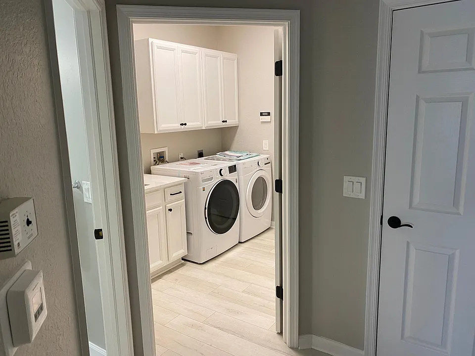 Laundry room leading out to a two car garage.