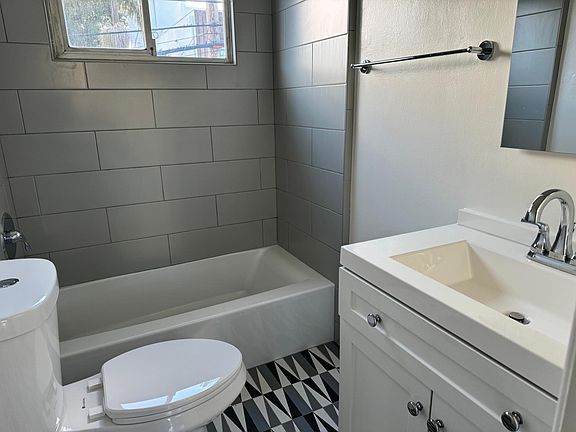 Bathroom with new bathtub, vanity and new toilet.
