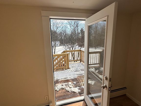 Exterior entryway leading to private deck and parking area below.