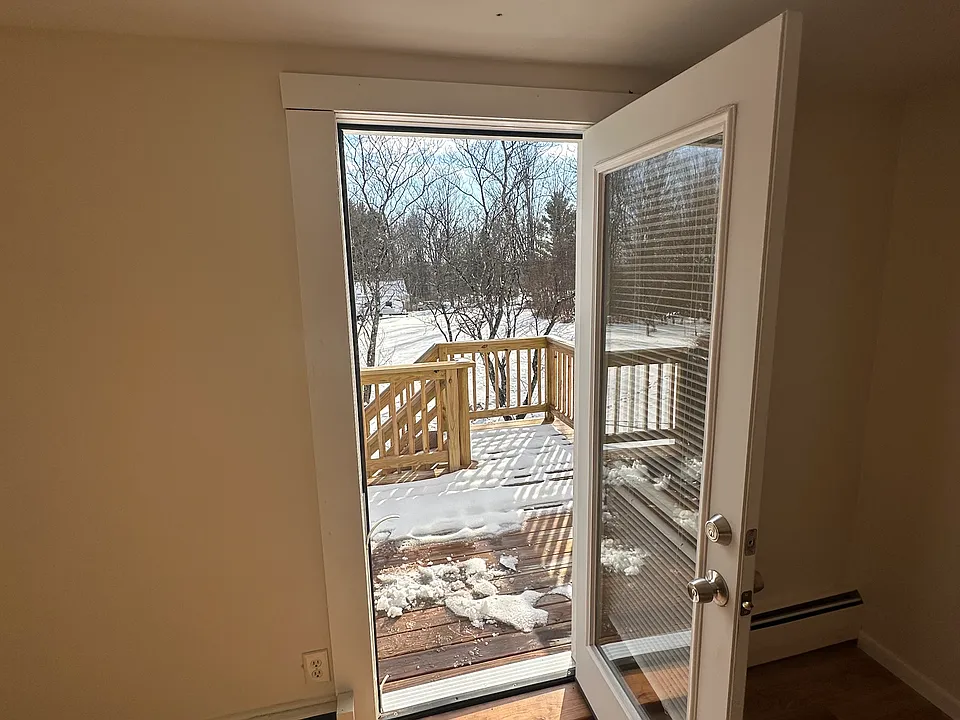 Exterior entryway leading to private deck and parking area below.