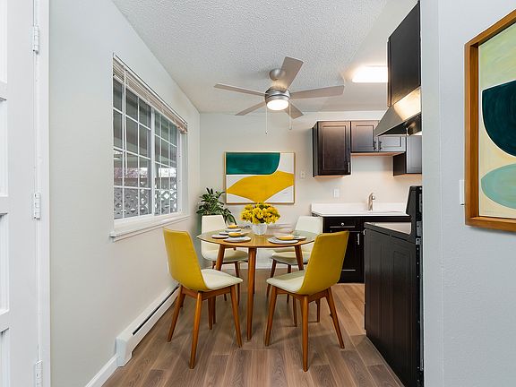 Enjoy meals in a vibrant dining area seamlessly connected to a sleek kitchen.