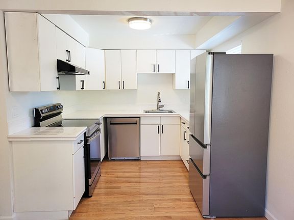 Bright white kitchen with all new stainless steel appliances
