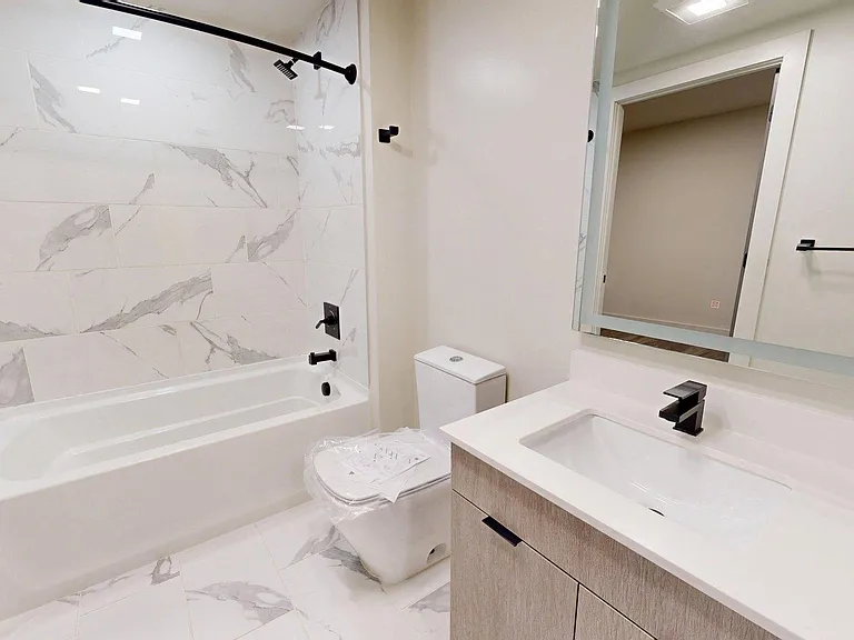partment Bathroom with large soaking tub and LED vanity mirror