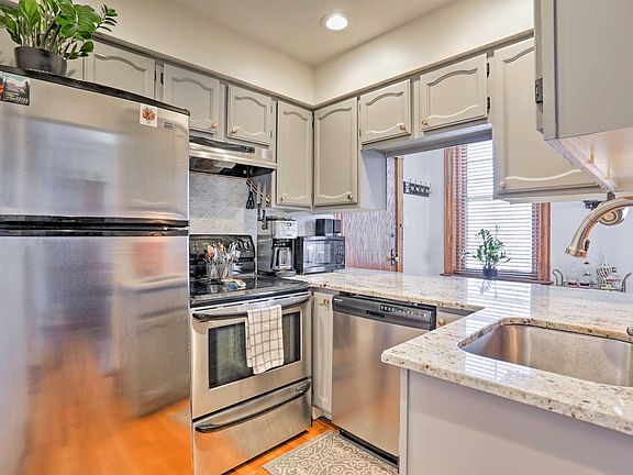 Kitchen with electric stove, refrigerator, dishwasher and microwave.
