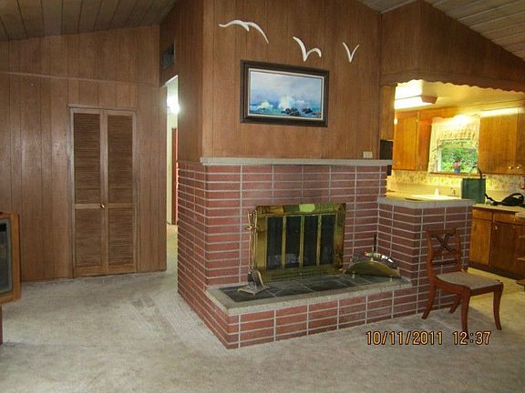 Open feeling with large wood burning fireplace and easy access to kitchen