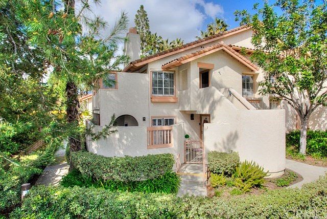 Mediterranean style home is truly charming inside and out