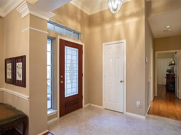 As you enter the home you find this spacious entry with low-maintenance tile floors and a convenient coat closet.