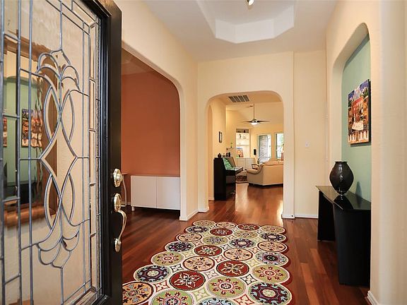 Wood floors greet you with bright paint tones to lift your spirit. Arched doorways and niches add that custom touch.