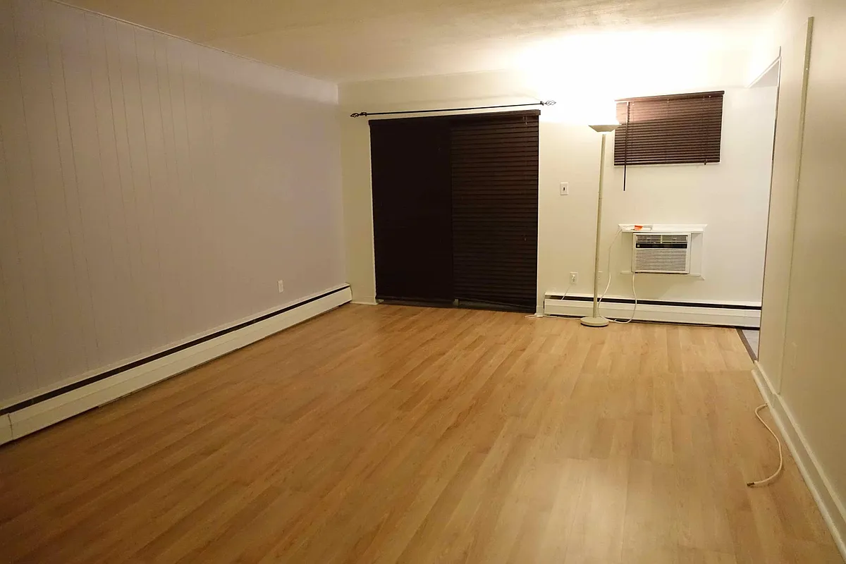 Dining room/Living room, facing private patio. Blinds and A/C included. - 59 Saint Paul St