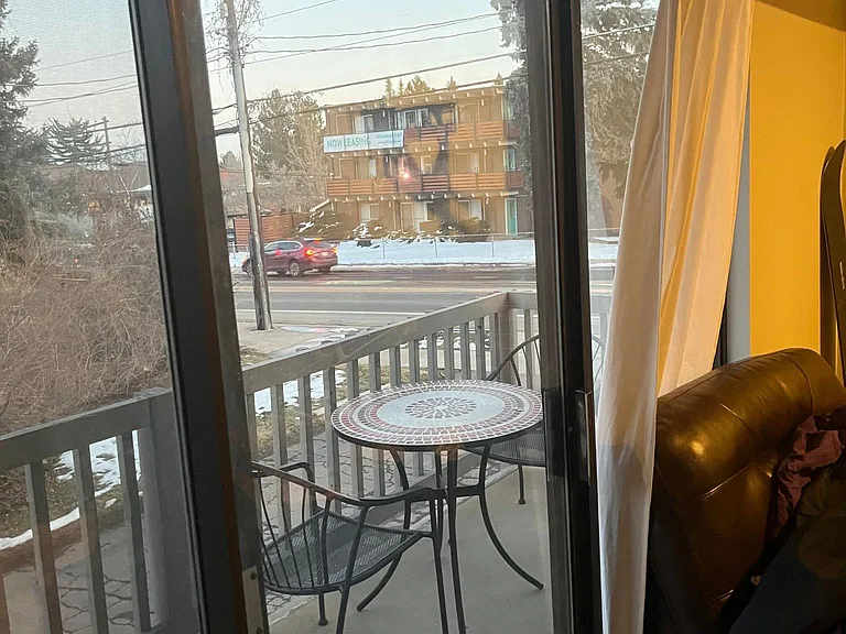 living room looking out onto porch/baseline road
