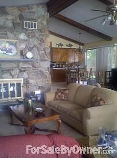 Living room with cathedrial ceilings, and beautiful stone fireplace.