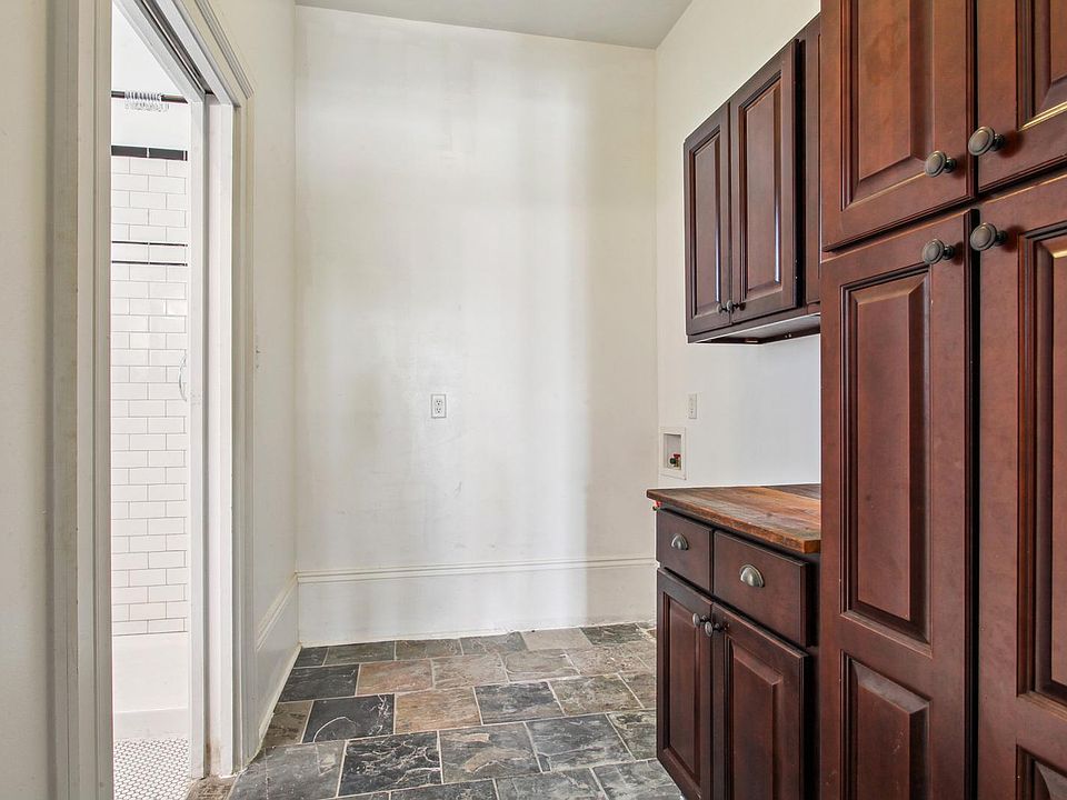 Slate flooring through kitchen and hallway, with plenty of storage and space for bicycles, and fitness.