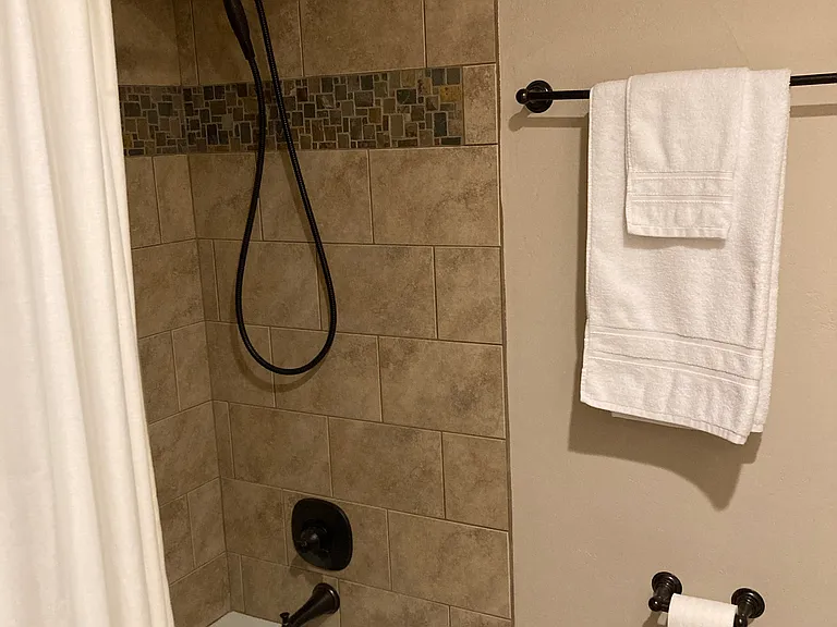 Hall bathroom includes tub and a shower with great water pressure.